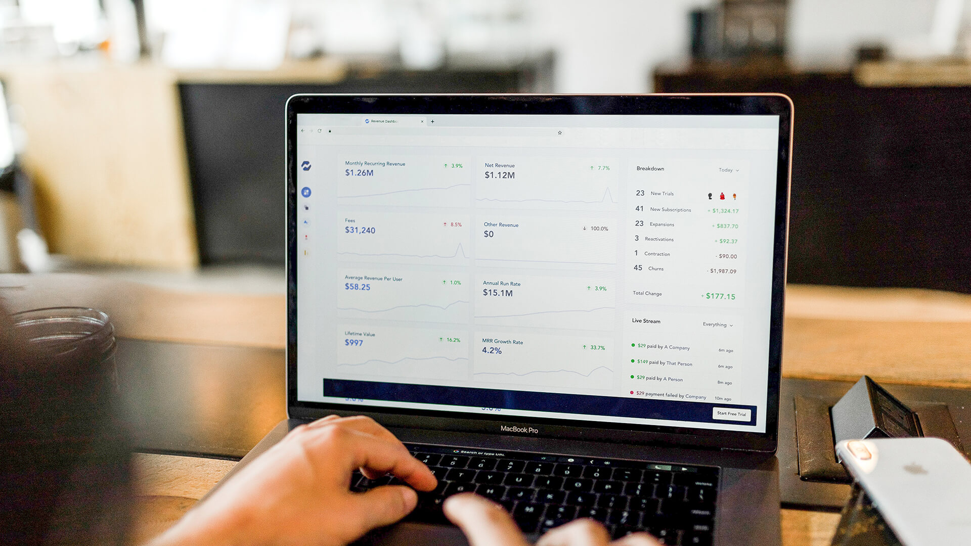 Laptop showing an organisations financial breakdown including revenue, growth and fees.