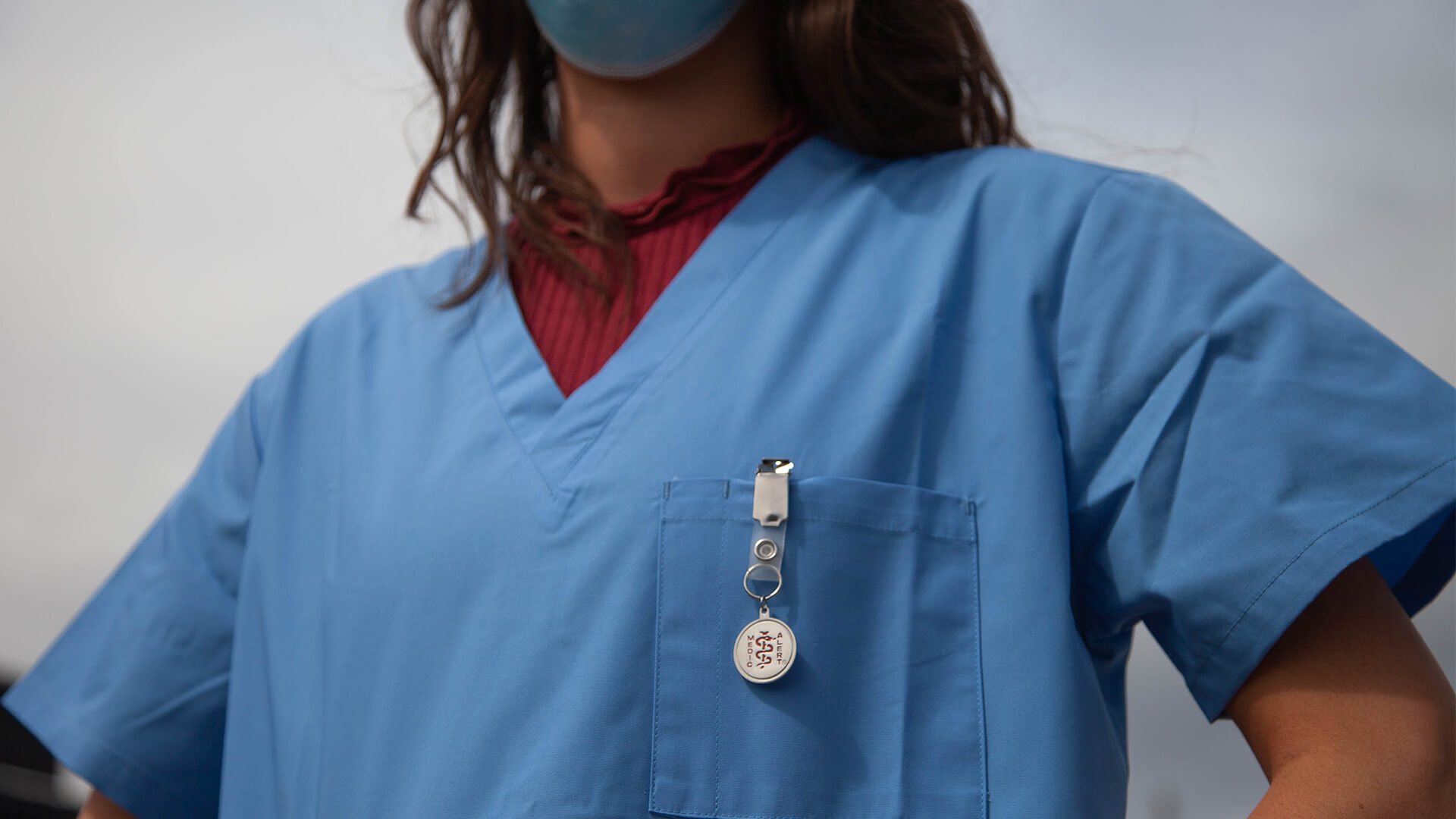 Nurse in blue scrubs.