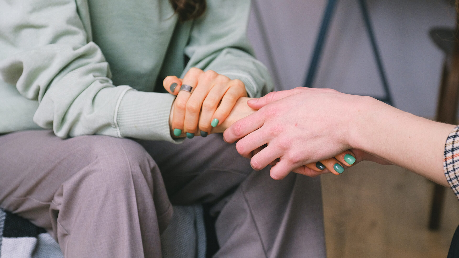 Two sets of hands holding each other.