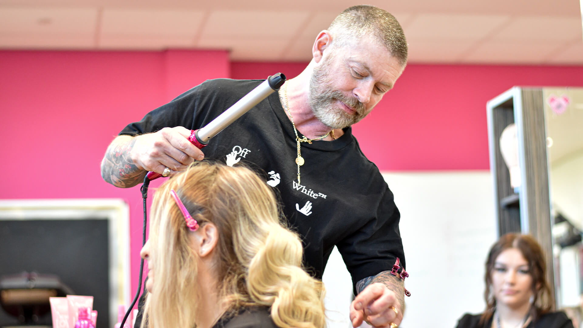 Lee Stafford styling a female students hair.