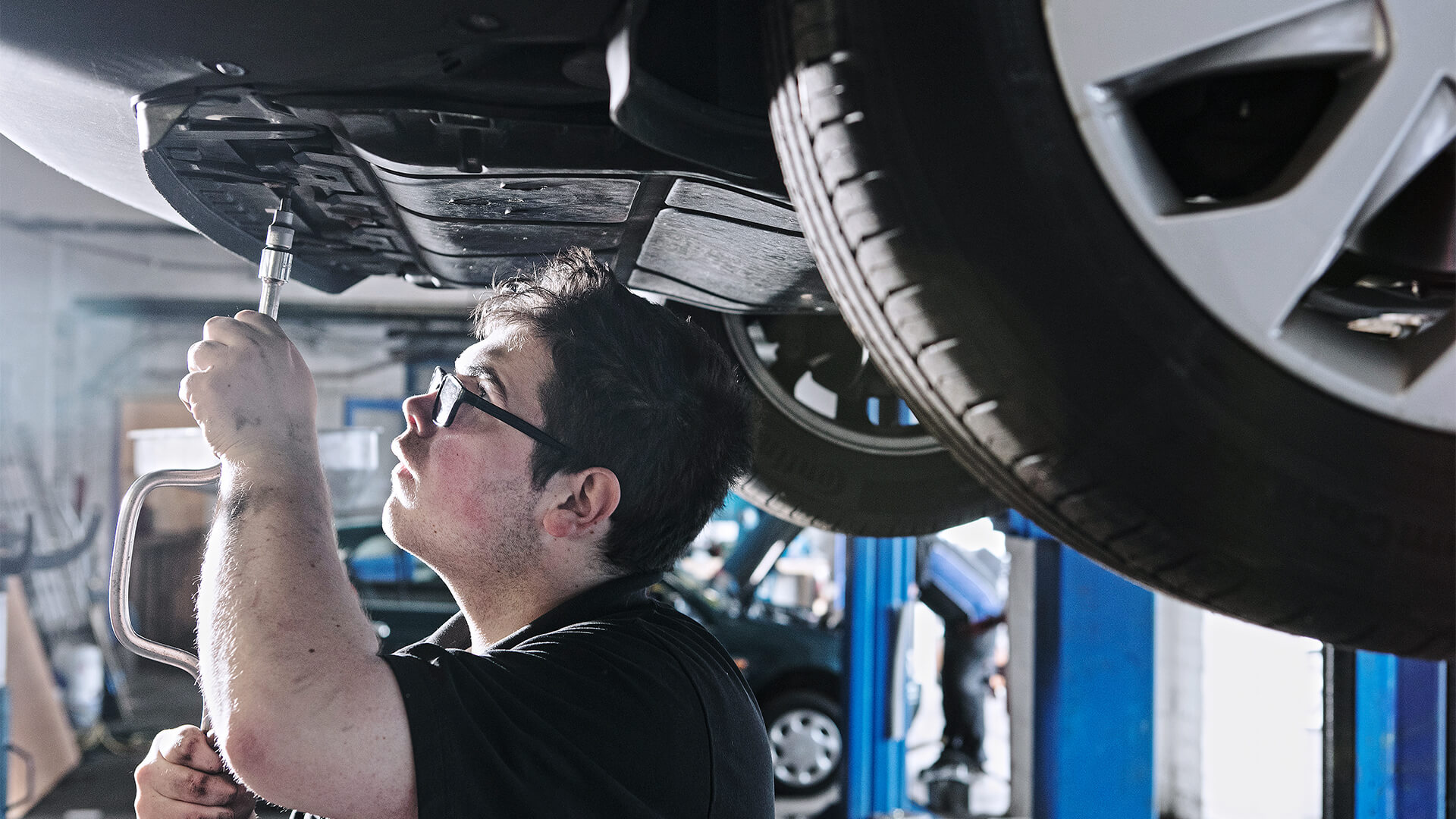 Man working on the underneath of a car.