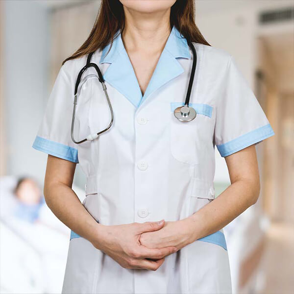 Woman in nurses uniform with a stethoscope around her neck.