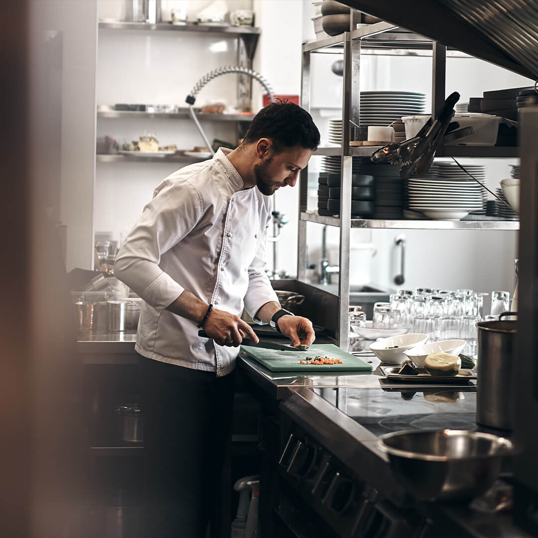 Male chef working in a commercial kitchen.