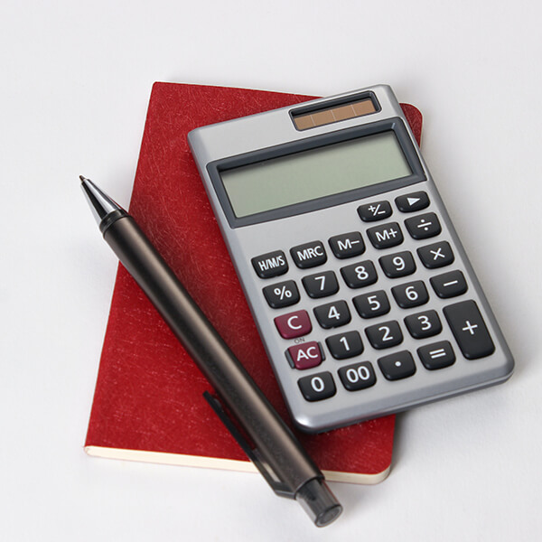 Red notepad, pen and calculator.