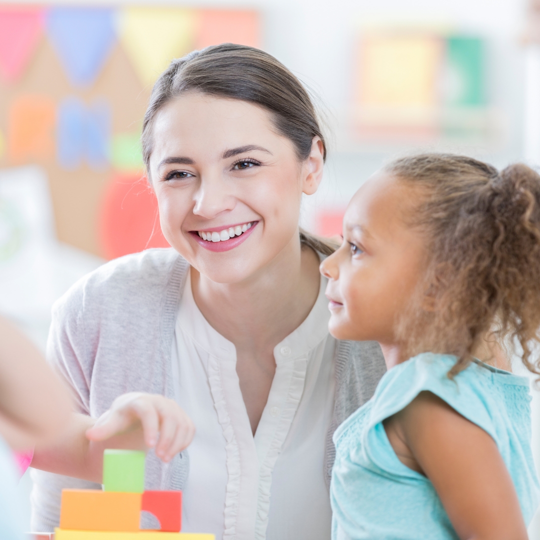 Teacher with children in classroom.