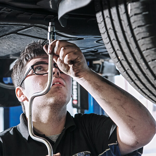 Man working on the underneath of a car.