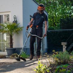 Man using a grass strimmer