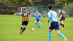 Football match with four players in action