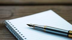 Close-up of a pen on a blank notebook