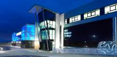 Exterior of East Durham College's Peterlee campus building lit up at night