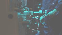 Close-up of an engineer turns dials on a machine