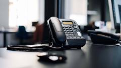 A black phone on a desk