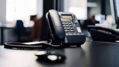 A black phone on a desk