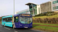 An Arriva Bus driving past East Durham College's Peterlee campus building