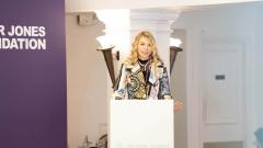 A girl giving a speech at a white lectern