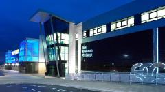 Exterior of East Durham College's Peterlee campus building lit up at night