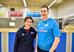 David Wylie, Head Coach, Basketball stood with a women wearing an top with a union jack on it