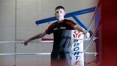 Darren Surtees rests against ropes in a boxing ring