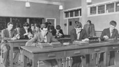 A black and white photo of the Easington College with men working in an electrical lab, circa 1950