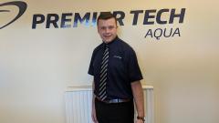 Ewan Archer stood in front of the Premier Tech Aqua Sign