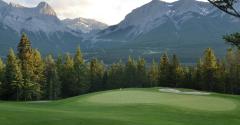 Golf course green with mountains in background