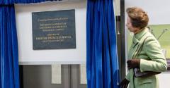 HRH The Princess Royal dressed in a green overcoat unveiling the Houghall development opening plaque in 2017