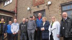 A group of staff and students stood outside the revamped Reeds building at Houghall