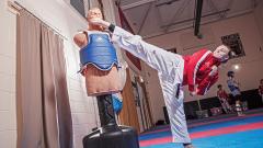 Simone Abley kicking a training mannequin's head