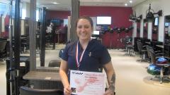 Suzanne Woodward poses in the hair salon at East Durham College holding her 3rd place barbering certificate