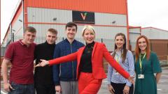 Heather Mills stood with fours students and Emma Norbury outside the Vbites factory in Peterlee