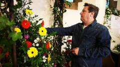 Male florist working on floral display in a church