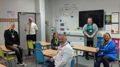 Six EDC staff sat at tables in classroom