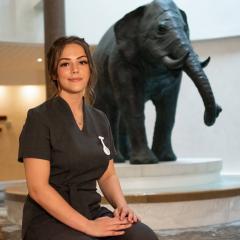 Catherine Rhodes sitting in front of stone elephant statue at Seaham Hall