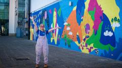 County Durham artist Hazel Oakes stood next to the new 14m wide mural she painted at East Durham College