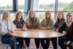 A group of six young ED6 students sat round a table