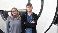 A photo of Hollie Ferguson and her brother Jacob Brown looking to camera with a blurred background