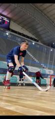 A photo of ED6 student Benjamin Millward playing roller hockey in a sports hall