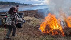 A person putting out a wild fire