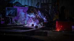 Man in welding mask creating sparks using welding gun