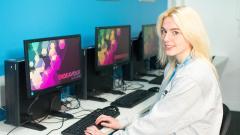 female student sat at a computer