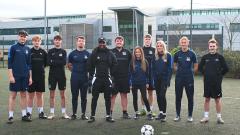 Jermain Defoe standing with sport students outside of East Durham College