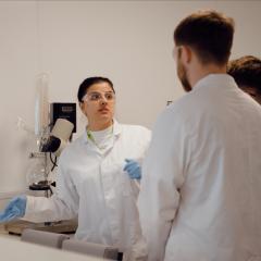 Person teaching students how to use machinery