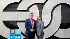 Andy Dodds, Regional Director of Robertson Homes &amp; Scott Bullock, Principal of East Durham College shaking hands in front of EDC logo